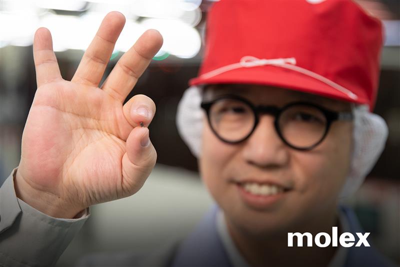 Molex employee holding a transistor between his fingers